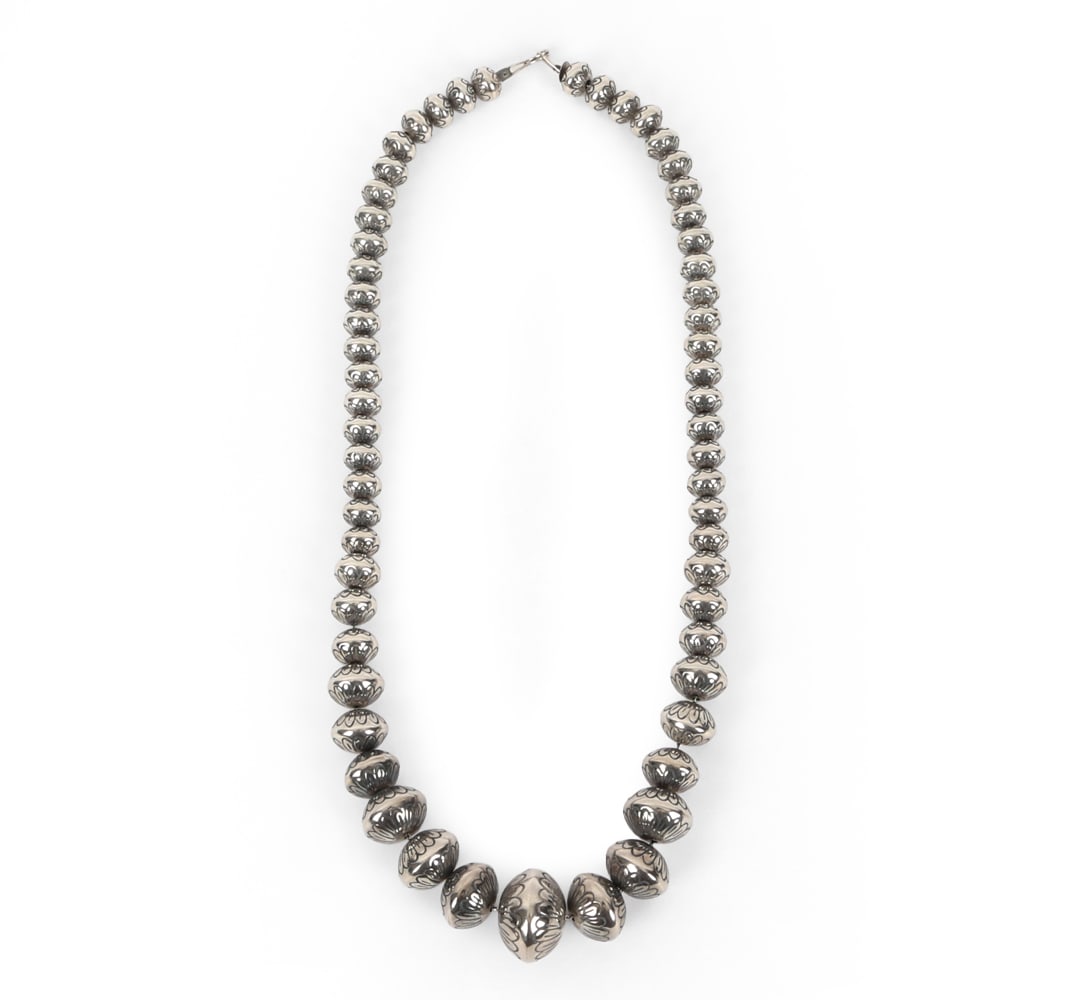 SOUTHWESTERN NAVAJO STERLING SILVER NECKLACE: Graduated beaded necklace. Incised "SW". Total Weight: 4.96 ozt. Dimensions: L 24.75". Condition: Faint scuffs and rubs. Wear consistent with age and use.