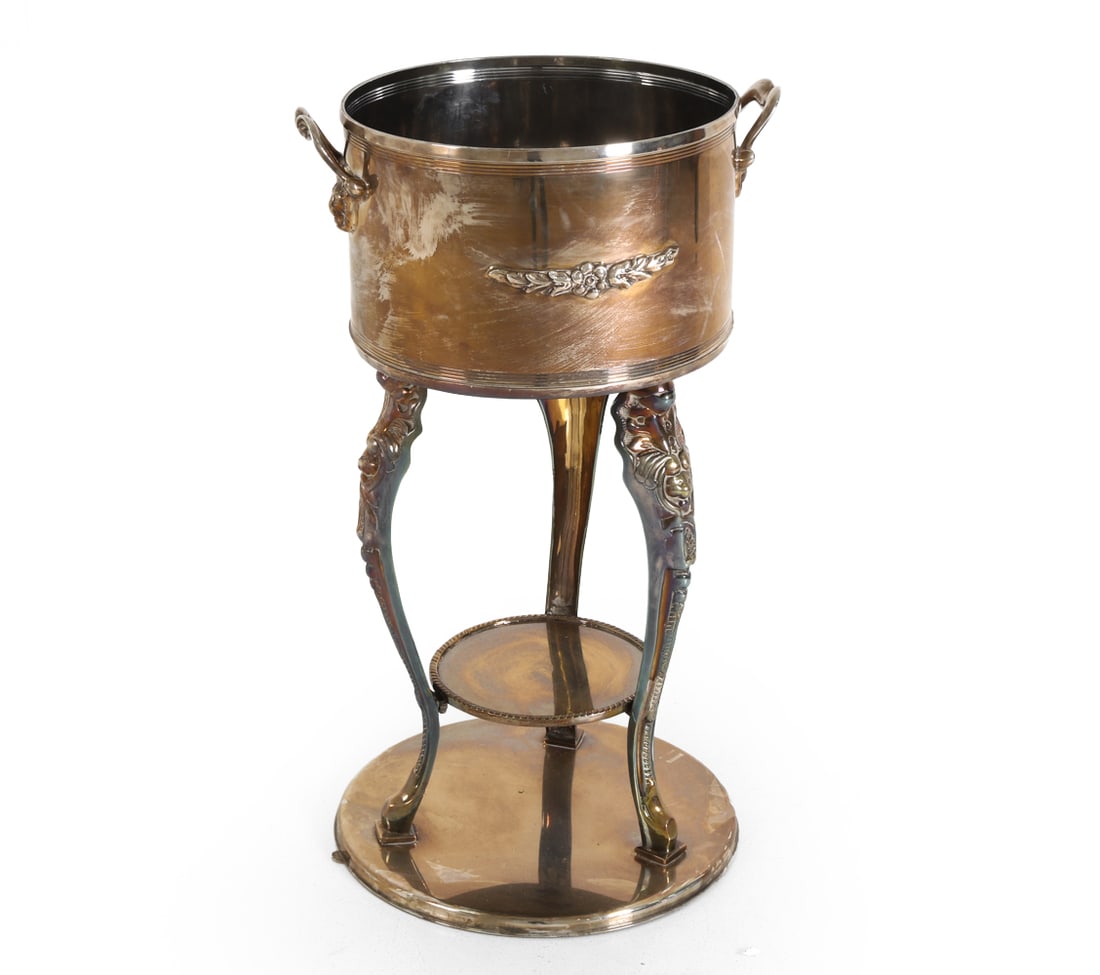 SILVERPLATE CHAMPAGNE OR WINE COOLER ON STAND: Wine cooler on stand. Dimensions: H 34.5" x W 20.5". Condition: Tarnish, Scuffs and rubs, wear consistent with age and use.