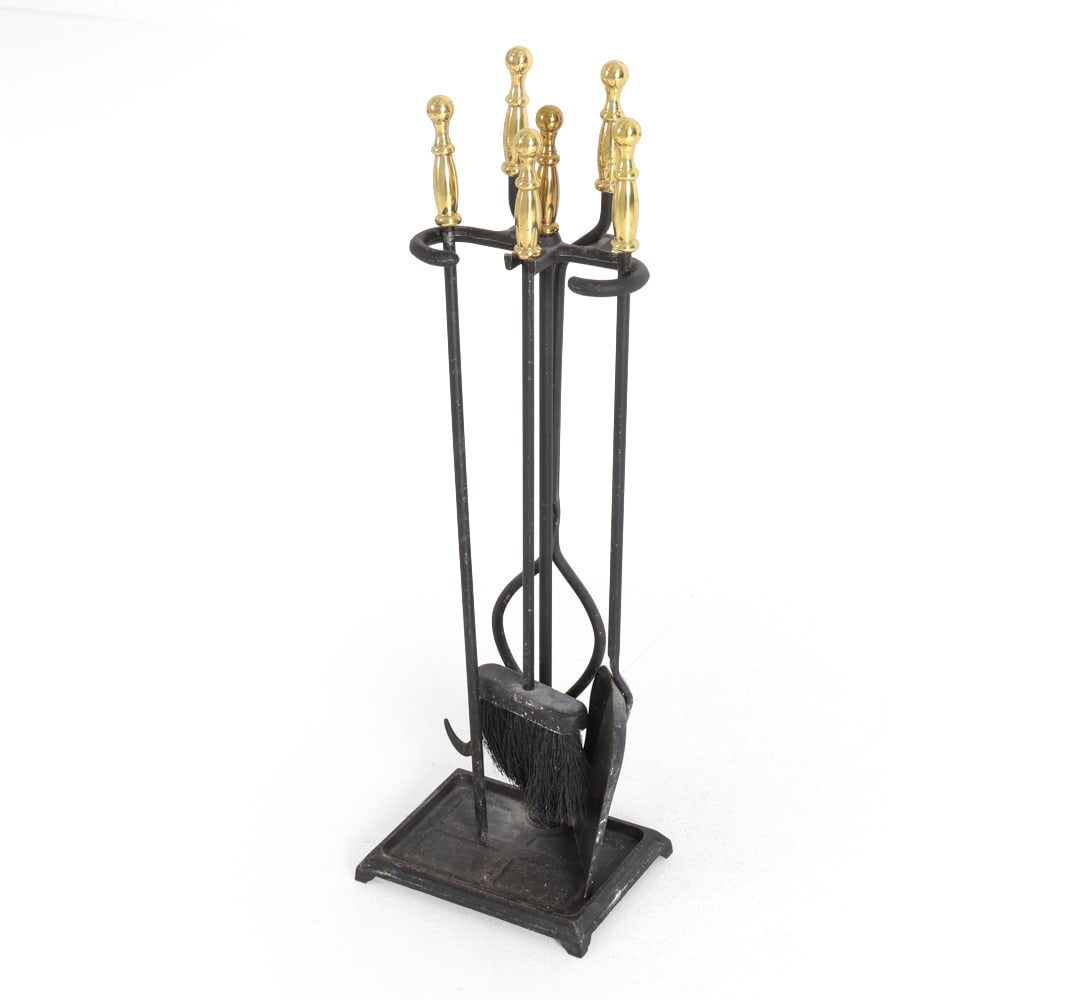 IRON AND BRASS FIREPLACE TOOLS: Wrought iron fireplace tools with polished brass handles. 20th century. Dimensions: Stand H 29.5" x W 9.75" x D 7.75". Condition: Scuffs and losses to black painted finish. Wear consistent with age an