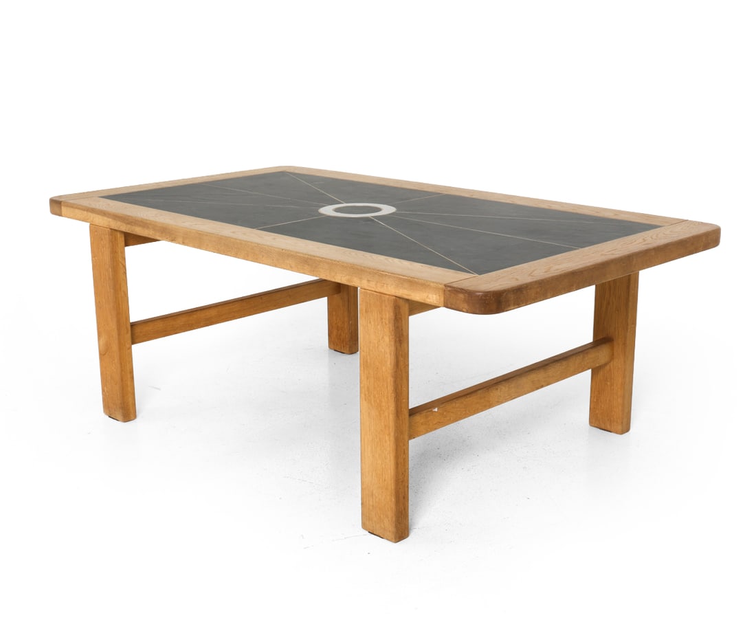 DANISH OAK & STONE COFFEE TABLE C. 1970S: Oak frame with slate stone and metal inlaid to top. Dimensions: H 19.75" x W 54" x D 30". Condition: Light scuffs and scratches to top. Water spots and sun fading. Wear consistent with age and use. E0