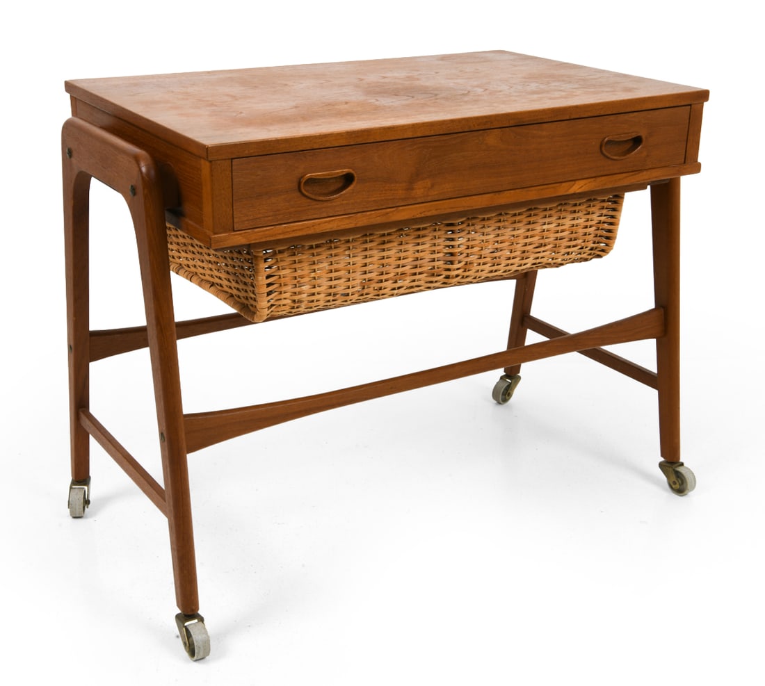 ATTR POVL DINESEN TEAK & RATTAN SEWING TABLE 1970S: On casters. Apparently unmarked. Dimensions: H 23" x W 23.75" x D 16". Condition: Faint water spots to top. Wear consistent with age and use. E078