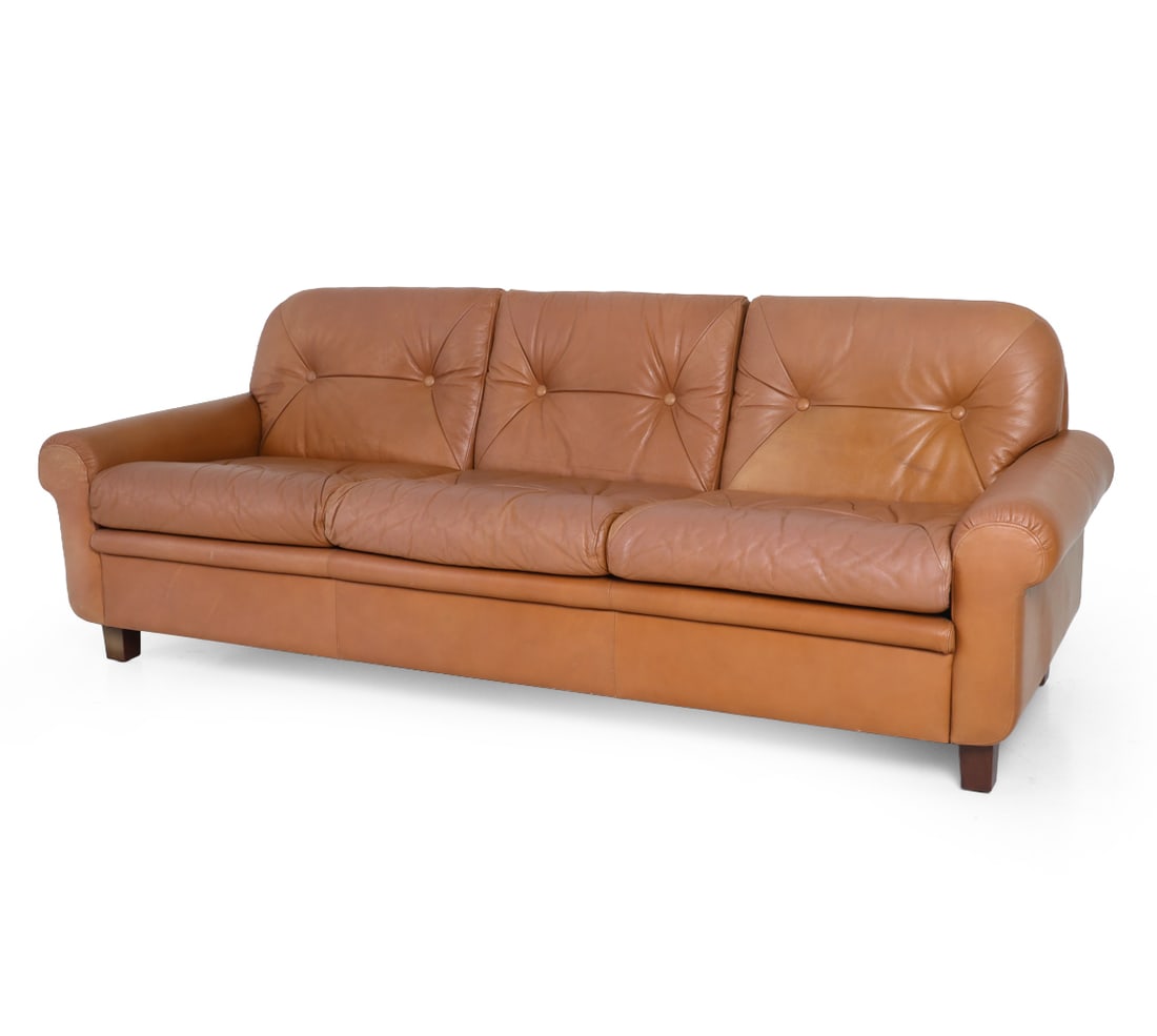 GEORG THAMS DANISH LEATHER SOFA C. 1960S: Apparently unmarked. Stained beech legs. Denmark, circa 1960s. Dimensions: H 31" x W 82" x D 31" x SH 17". Condition: Scuffs, rubs, and slight fading to leather. White spots to fabric underneath. Wear