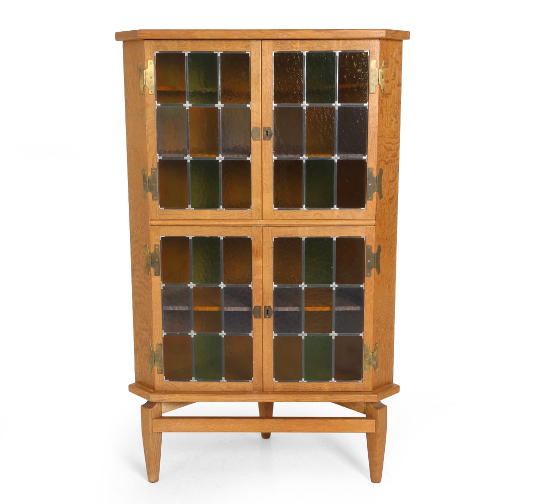 HENNING KJAERNULF OAK & GLASS CORNER CABINET 1960S: Key included. Stained glass panel doors. Apparently unmarked. Denmark, circa 1960s. Dimensions: H 57" x W 36" x D 23.5". Condition: Wear consistent with age and use, including minor scuffs and scratch