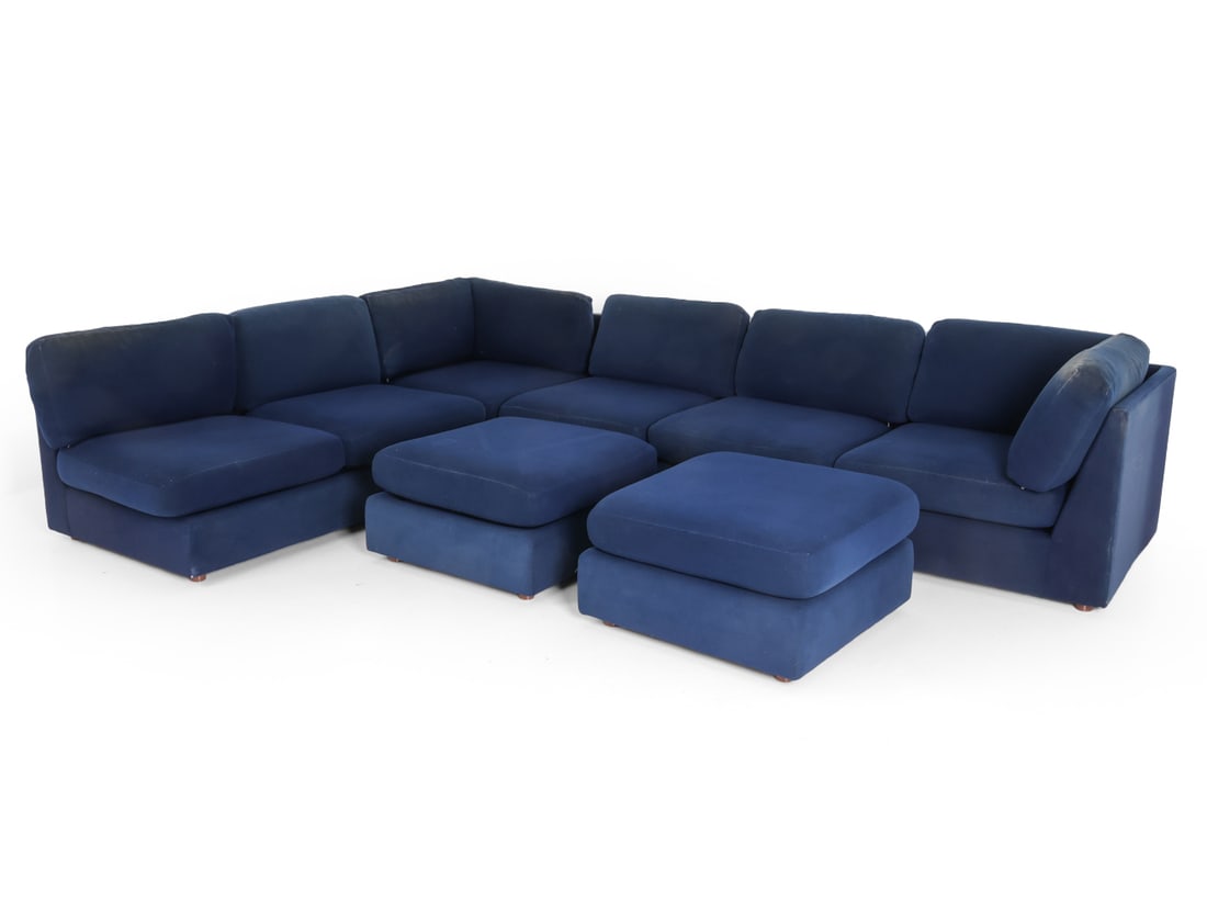 20TH C. MODULAR SOFA W/ OTTOMANS FOR REUPHOLSTERY: (6) sections with backrests and (2) ottomans. Dimensions: H 26" x W1 120" x W2 90" x D 33" x SH 14" (Ottoman) H 9" x W 28" Condition: Reupholstery recommended, Fading and discoloration. Wear