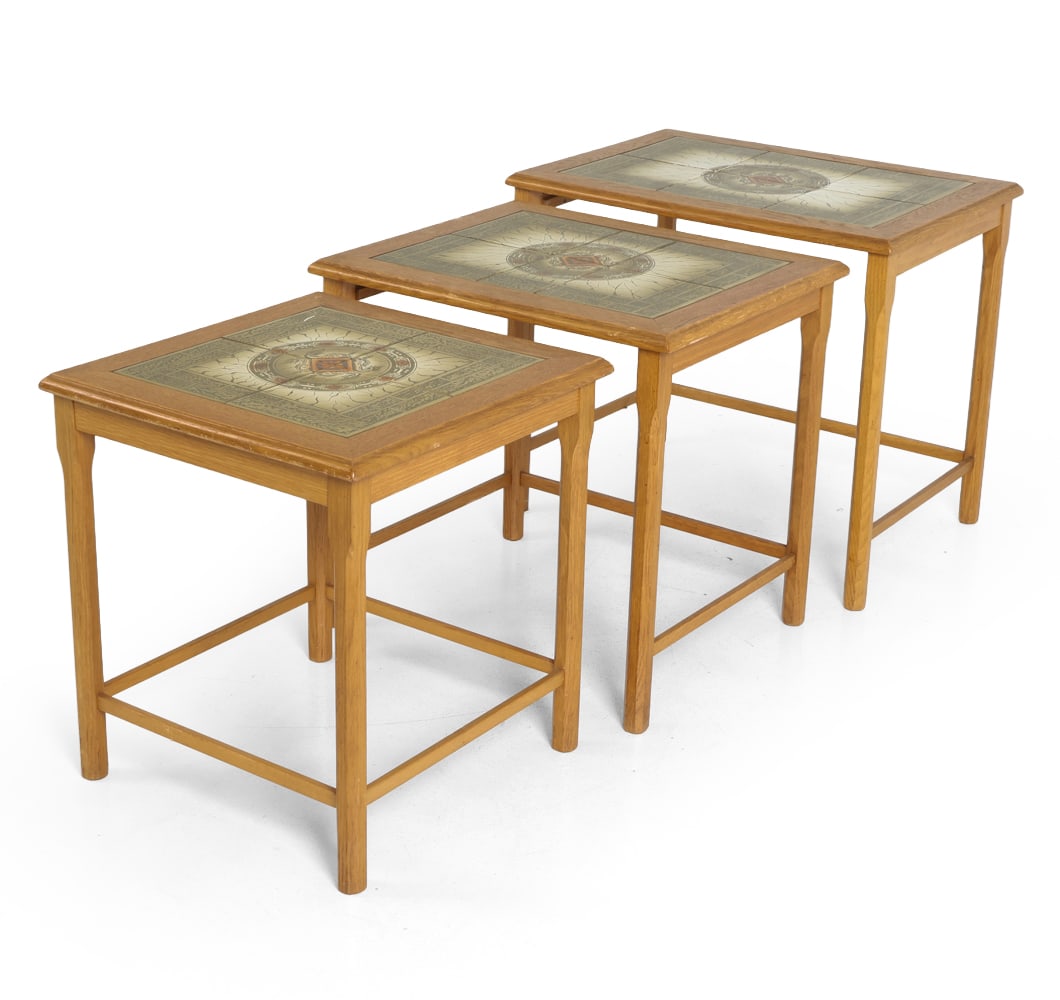 ATTR. TOFTEN DANISH OAK & TILE NESTING TABLES: Ceramic tile top nesting table in oak frame. Sculptural tapered legs with stretchers. Denmark, circa 1970s. Dimensions: Largest H 19" x W 22" x D 16.5". Condition: Crack to tiles on smallest table. Wa