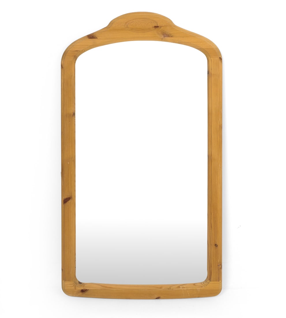 SCANDINAVIAN PINE WALL MIRROR C. 1970S: Pine framed mirror with a curved design. Apparently unmarked. Dimensions: (Frame) H 45" x W 25" (Mirror) H 38" x W 20.5" Condition: Wear consistent with age. Nicks, scuffs to frame.