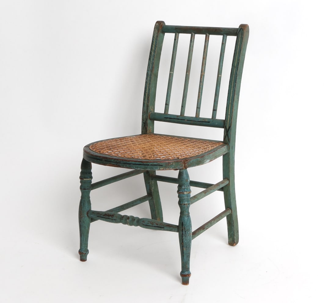 19TH C. ANTIQUE PAINTED WOOD & CANE CHILDS CHAIR: Miniature chair with painted wooden frame and caned seat. Mid to late 19th century. Dimensions: H 17.25" x W 9" x D 10" x SH 8.75". Condition: Minor losses to caning. Split to seat where front leg is 