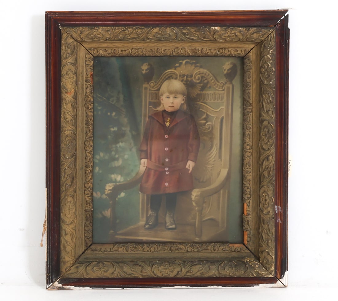 ANTIQUE CHROMOLITHOGRAPH OF A CHILD: Colored lithograph featuring a young child standing on a chair. Early 1900s. Dimensions: Frame H 29" x W 24.5". Sight H 19.75" x W 15.25". Condition: Losses to frame. Previous repair to corner of fram