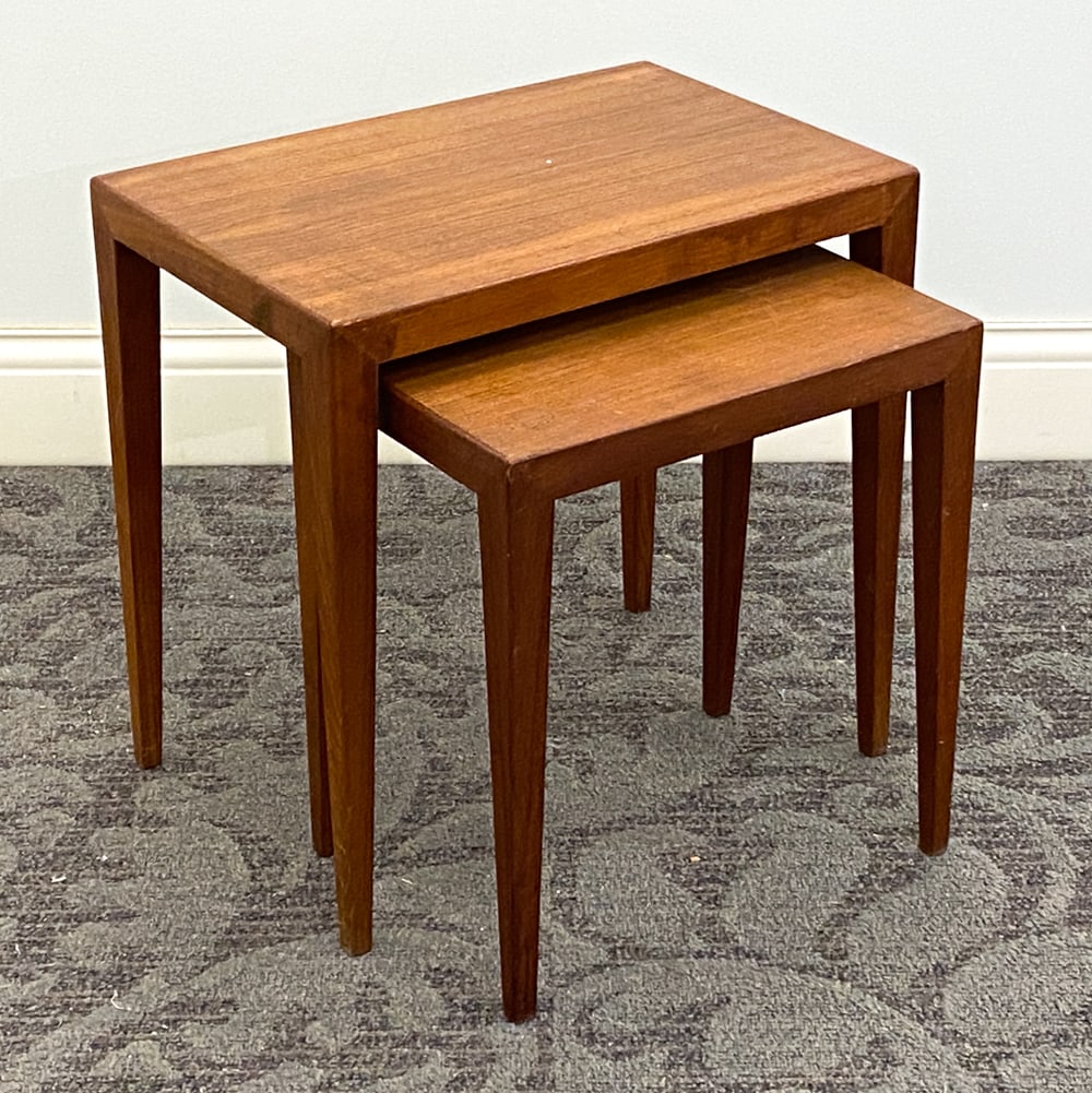 ATTR. SEVERIN HANSEN DANISH TEAK NESTING TABLES: (2) Nesting tables. Unmarked. Denmark, circa 1960s. Dimension: H 18.25" x W 18.75" x D 12.5" Condition: Wear consistent with age and use including minor dings and rubs to table top and legs.
