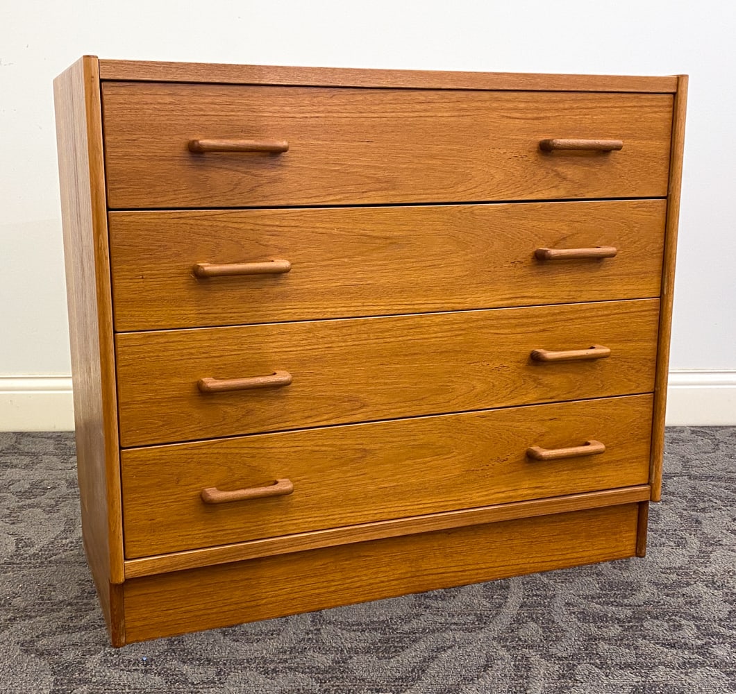 SWEDISH TEAK CHEST OF DRAWERS C. 1970S: Teak chest of drawers with carved handles to drawers. Sweden, circa 1970s. Dimensions: H 29.25" x W 33" x D 16". Condition: Faint scuffs to edges. Wear consistent with age and use.