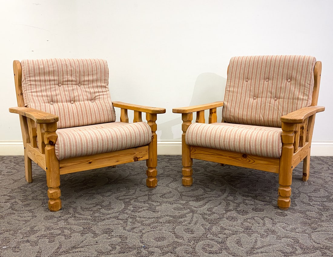 PAIR OF SWEDISH BRUTALIST PINE LOUNGE CHAIRS 1960S: (2) Brutalist pine armchairs in slatted design to back and sides. Sweden, circa 1960s. Dimensions: H 32.5" x W 30" x D 31.5" x SH 16.25". Condition: Slats and arms loose to one. Scuffs, scratches, din