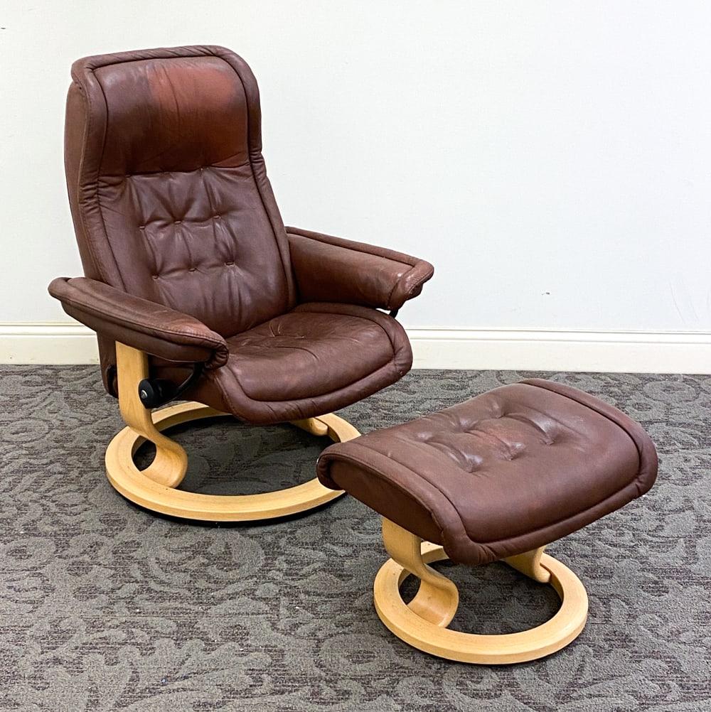 EKORNES STRESSLESS LEATHER LOUNGE CHAIR & OTTOMAN: Model Royal. Marked to glide wheel. Norway, 20th century. Dimensions: H 40" x W 29" x D 27" x SH 19" Condition: Wear consistent with age and use. Soiling underneath the chair & ottoman. Some creasing.