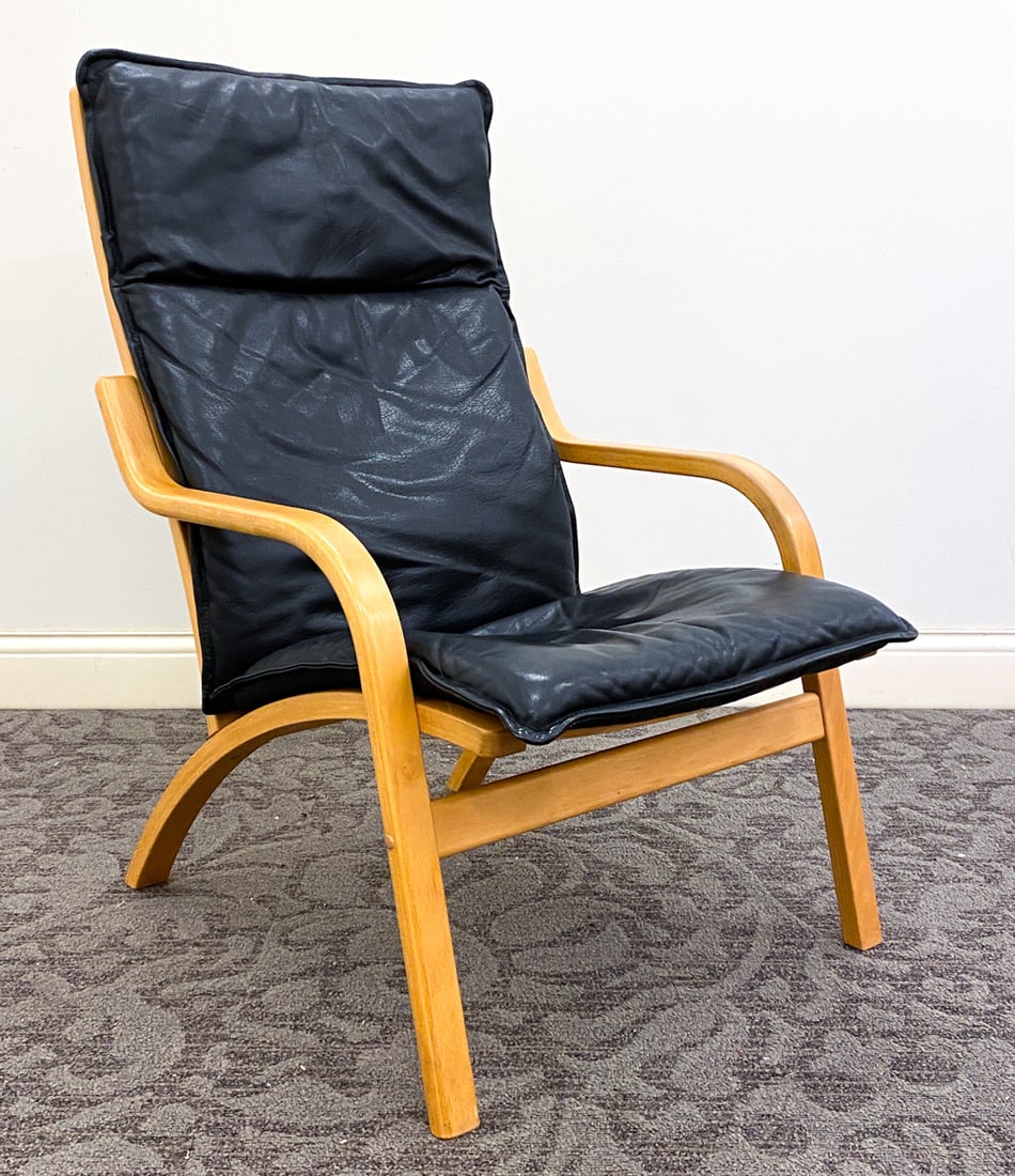STOUBY DANISH LEATHER LOUNGE CHAIR C. 1970S: Marked underneath cushions. Dimension: H 38" x W 24.75" x D 32" x Sh 16.5" Condition: Wear consistent with age and use including minor rubs and scuffs to armrest and legs.