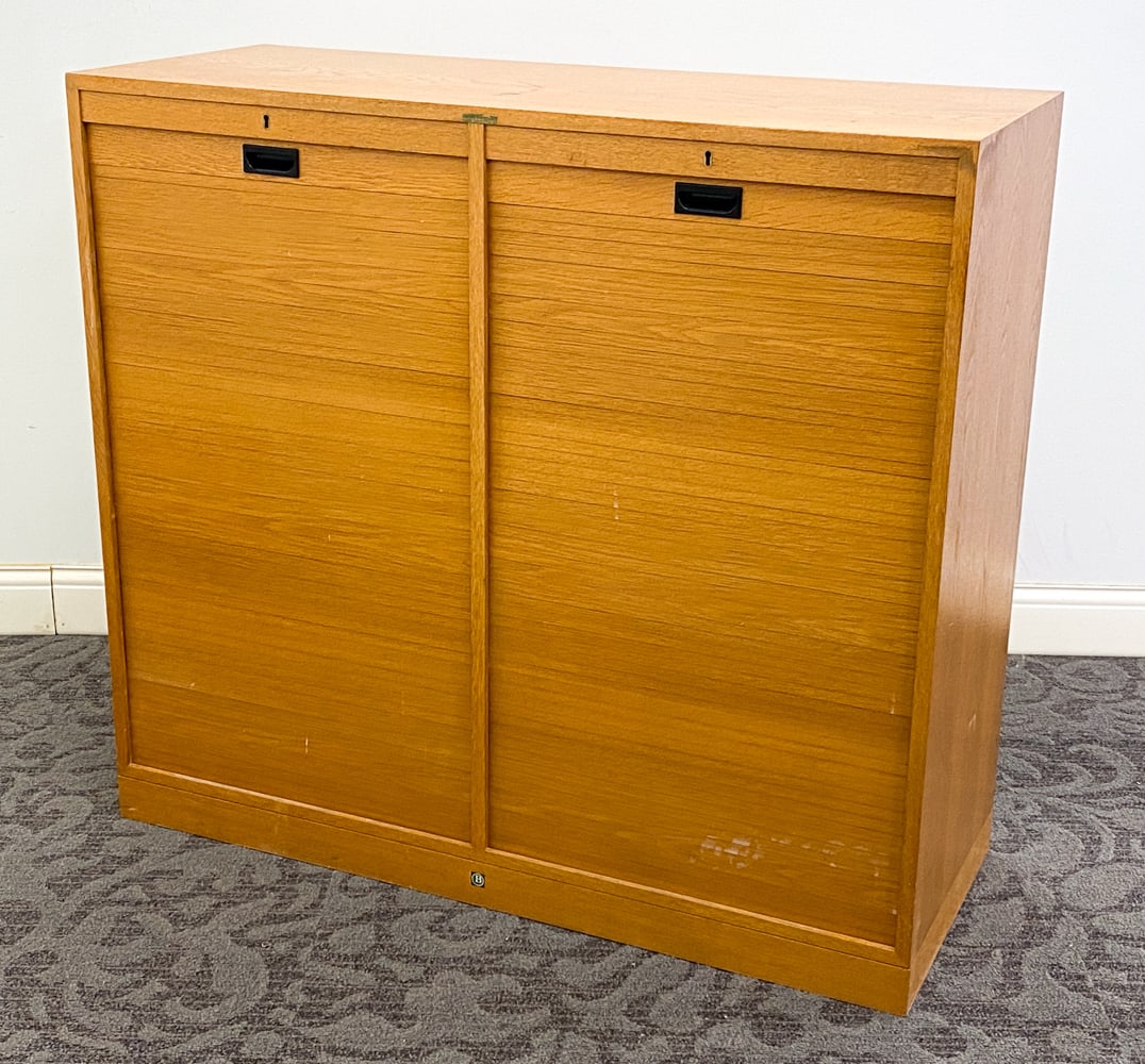 BJERRINGBRO DANISH OAK TAMBOUR CABINET C. 1960S: Key included. Apparently unmarked. Denmark, circa 1960s. Dimension: H 42.25" x W 46.5" x D 18.25" Condition: Marks of discoloration to top, Minor rubs and scuffs to sides and top, Wear consistent with