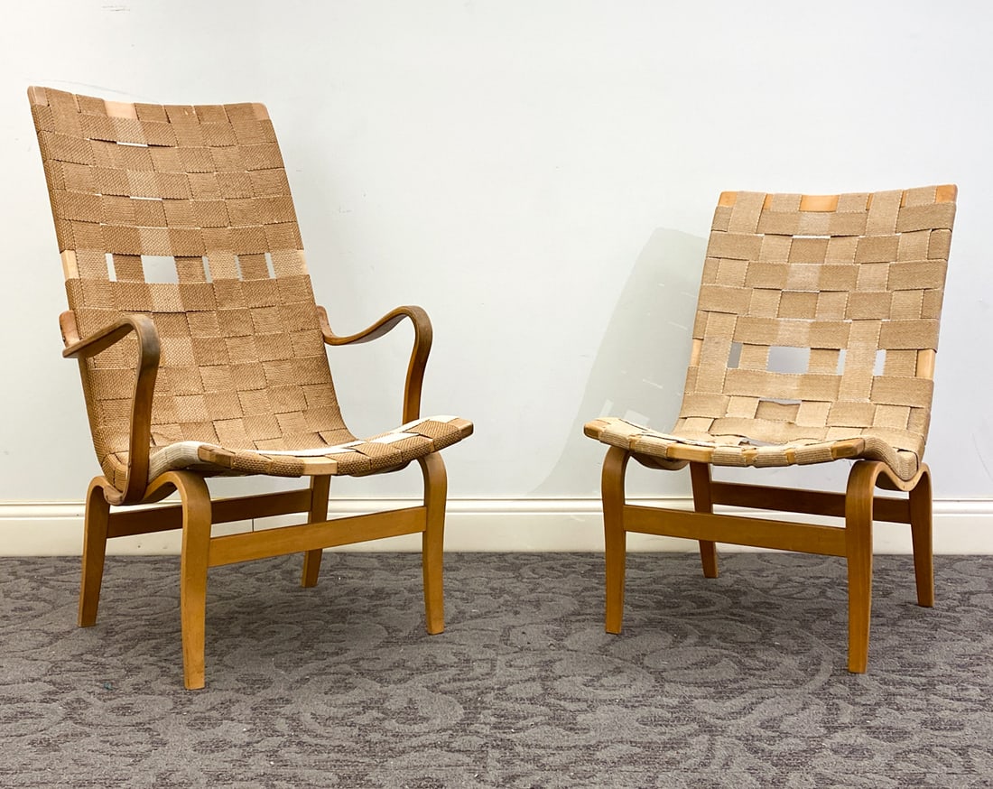 (2) BRUNO MATHSSON EVA LOUNGE CHAIRS C. 1960S: Apparently unmarked. Sweden, circa 1960s. Dimensions: H 41" x W 25" x D 31" x Sh 15" Condition: One example without armrests. Discoloration to seat and backrest, loss to woven webbing, Wear consistent
