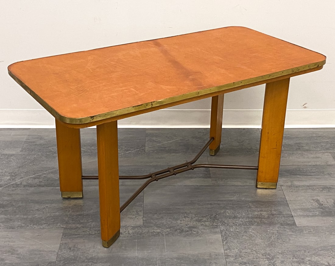 DANISH BEECH & LEATHER COFFEE TABLE C. 1950S: Unmarked. Beech coffee table with leather top and brass trim. Dimensions: H 23.5" x W 45.25" x D 23.75" Condition: Dents and patina to brass. Wear consistent with age and use. Marks to top. Fading.