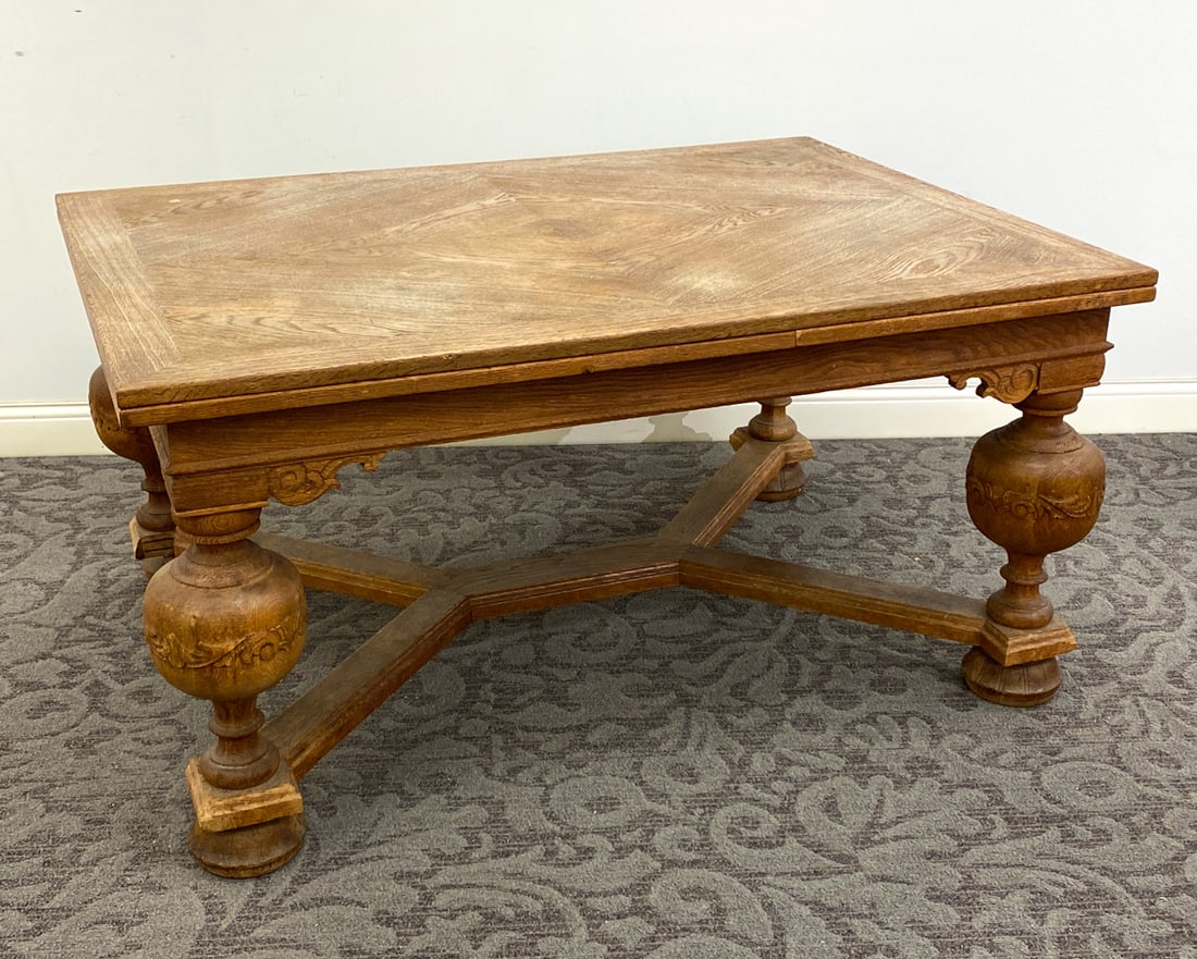 SCANDINAVIAN CARVED OAK EXTENDING DINING TABLE: Includes two pull out leaves. Dimensions: H 29.5" x W 59" x D 43.25" x (Leaf) W 23.5" Condition: Wear consistent with age and use including minor rubs and scuffs to table top and legs. Bottom of one l