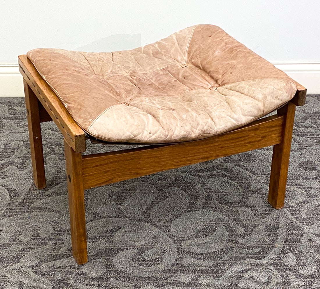 TORBJORN AFDAL FOR BRUKSBO HUNTER LEATHER OTTOMAN: Apparently unmarked. Norway, circa 1970s. Dimensions: H 16.25" x W 25" x D 20" Condition: Minor water spots to cushion and base, Sun-fading to cushion, Wear consistent with age and use.