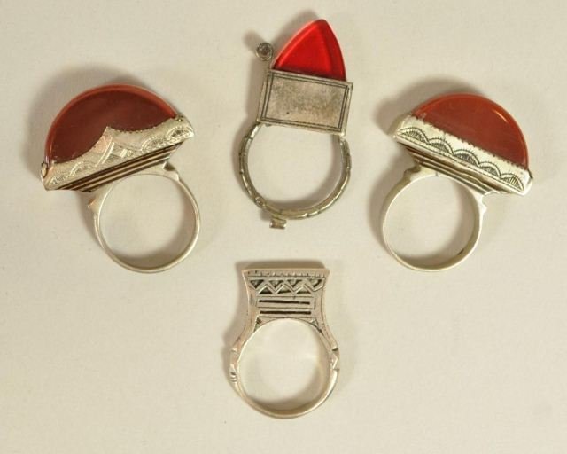 4 MOROCCAN BERBER SILVER RINGS W/ AGATE: Lot of 4 Moroccan Berber silver rings with carnelian or agate stones. Dimensions: 1.75" tall (largest) Ring sizes: 10-11 From a Port Chester, NY Estate