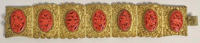 CHINESE CARVED CINNABAR & FILIGREE BRACELET: Chinese carved cinnabar and gold over copper bracelet. Marked CHINA on the back. Condition: Good, wearable condition with working clasp. Loss to the plating on the back. Dimensions: L 7.25" X 1.5 From
