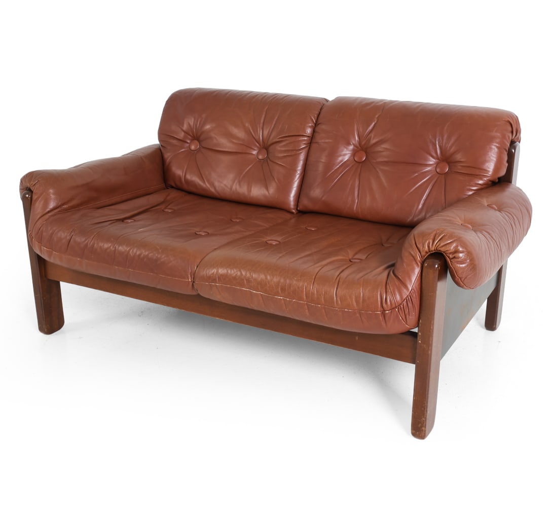 COJA STYLE DANISH BRUTALIST LEATHER LOVESEAT 1970S: Dimensions: H 28.5" x W 56" x D 34.5" x SH 15.25". Condition: Scuffs to leather and wood. Wear consistent with age and use. PT021