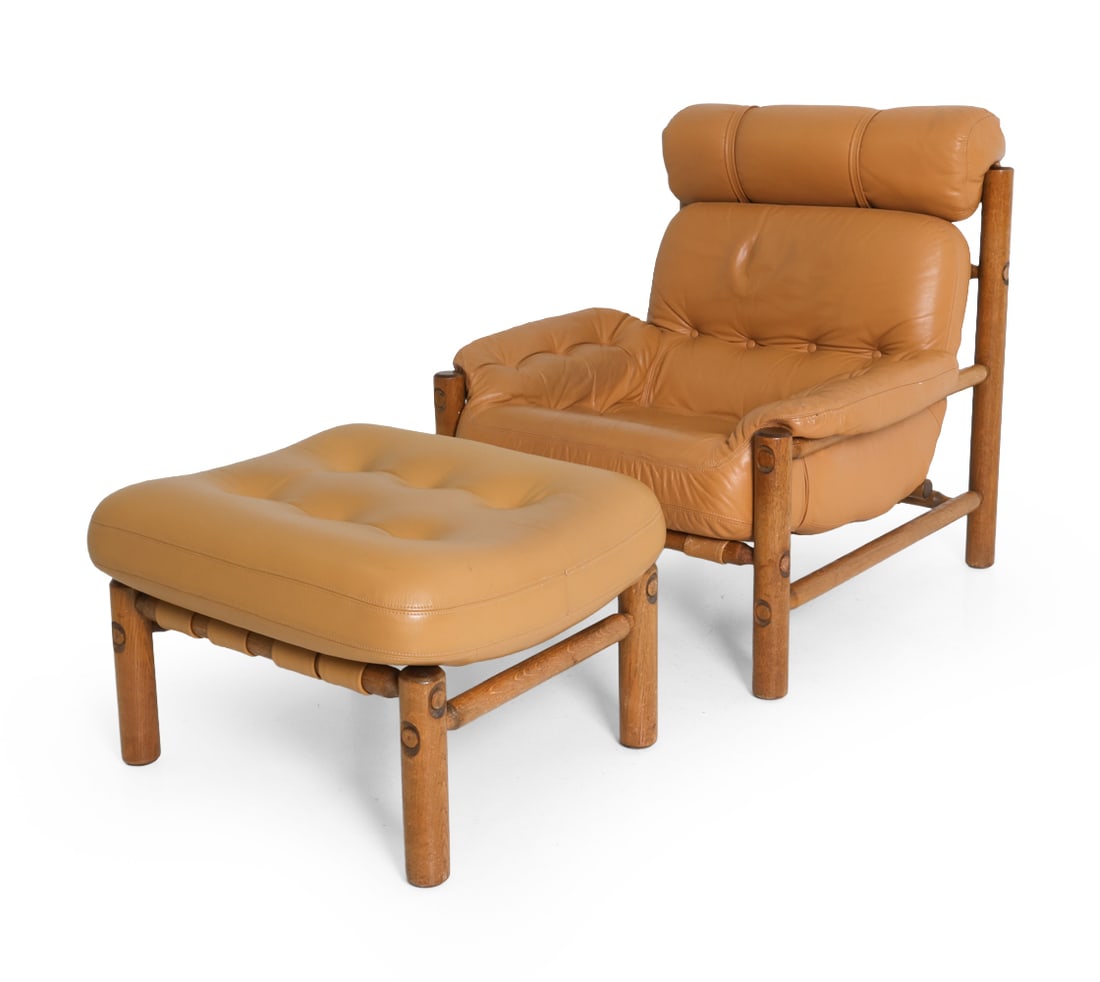 ARNE NORELL STYLE OAK & LEATHER LOUNGE CHAIR: Dimensions: Chair H 35" x W 30" x D 32" x SH 15.5". Ottoman H 17.5" x W 22" x D 22". Condition: Scuffs and rubs to wood and leather. Discolored area underneath chair. Wear consistent with age and use.