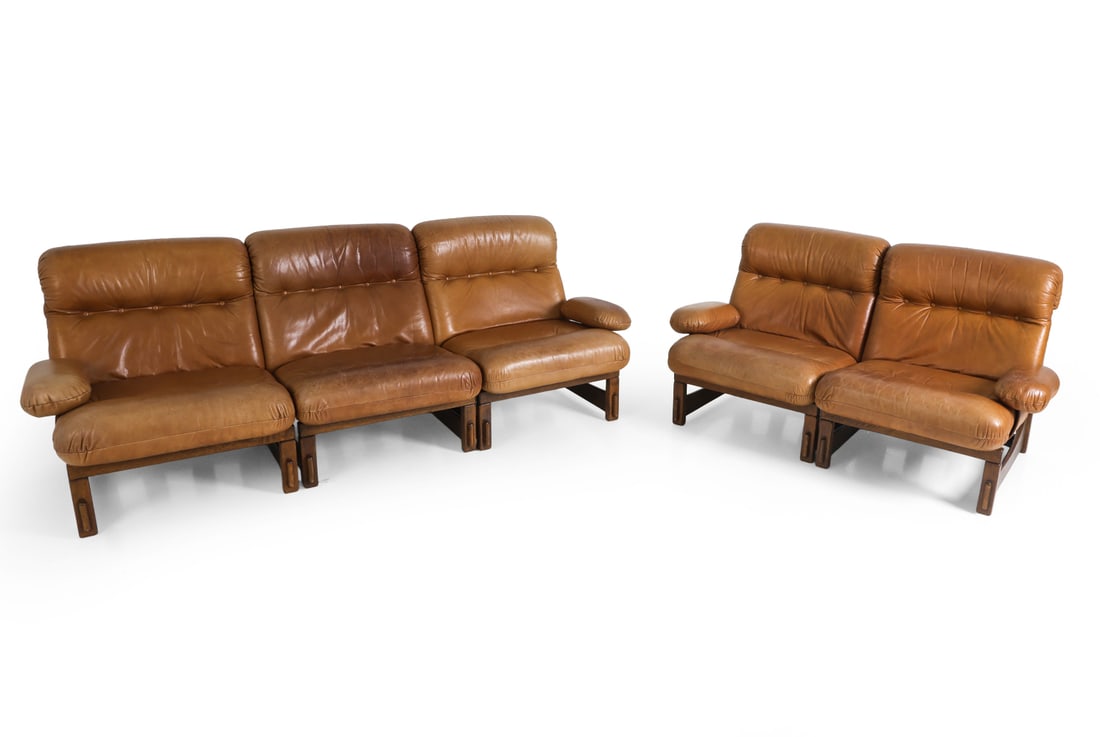 STRAUB STYLE BRUTALIST OAK & LEATHER MODULAR SOFA: (5) Modular pieces. Circa 1970s. Dimensions: Largest Section As Shown H 32" x W 87 x D 33" x SH 16". Condition: Light scuffs and scratches to leather and wood, few faintly discolored areas. Wear consi