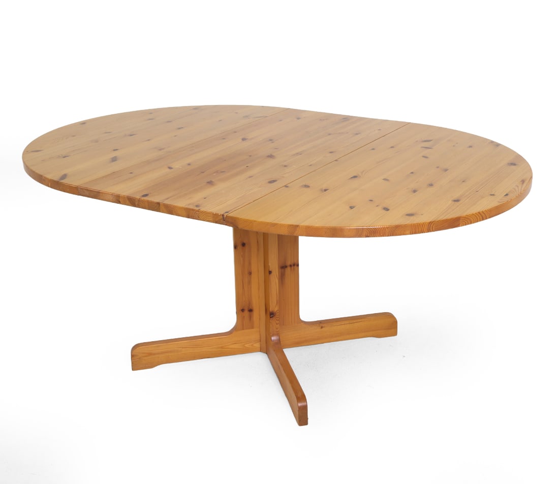 ASKO FINNISH PINE EXTENDING DINING TABLE C. 1970S: (1) Leaf included. Marked underneath. Dimensions: H 29" x Dia. 45.5". Leaf W 20.5". Condition: Scuffs and scratches. Wear consistent with age and use. PT082