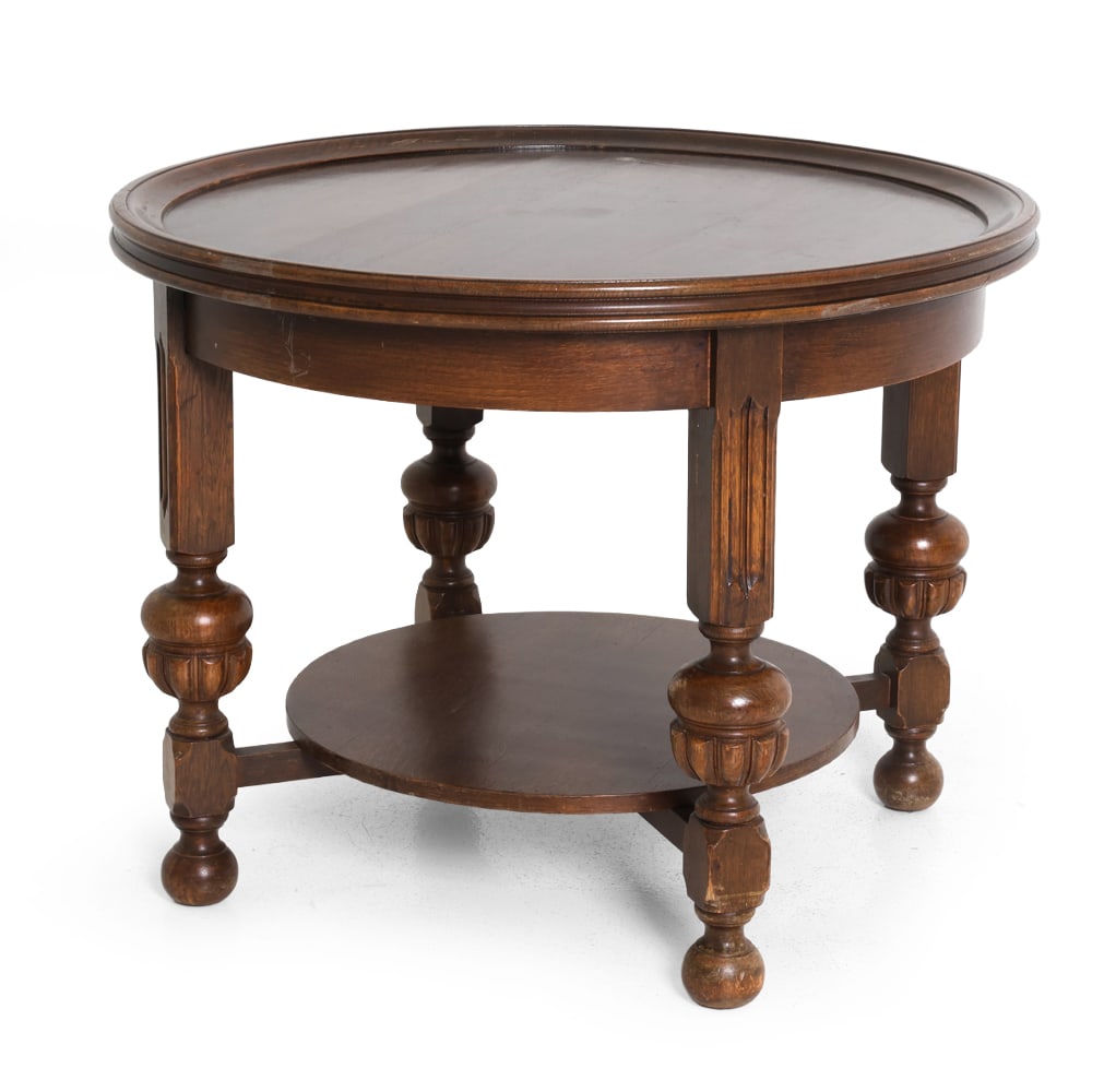 BAROQUE STYLE DUTCH OAK SIDE TABLE C. 1950S: Dimensions: H 24.5" x Dia. 30.5". Condition: Crack to Underside support for the bottom shelf. Wear consistent with age and use. Previous repairs to base. PT004