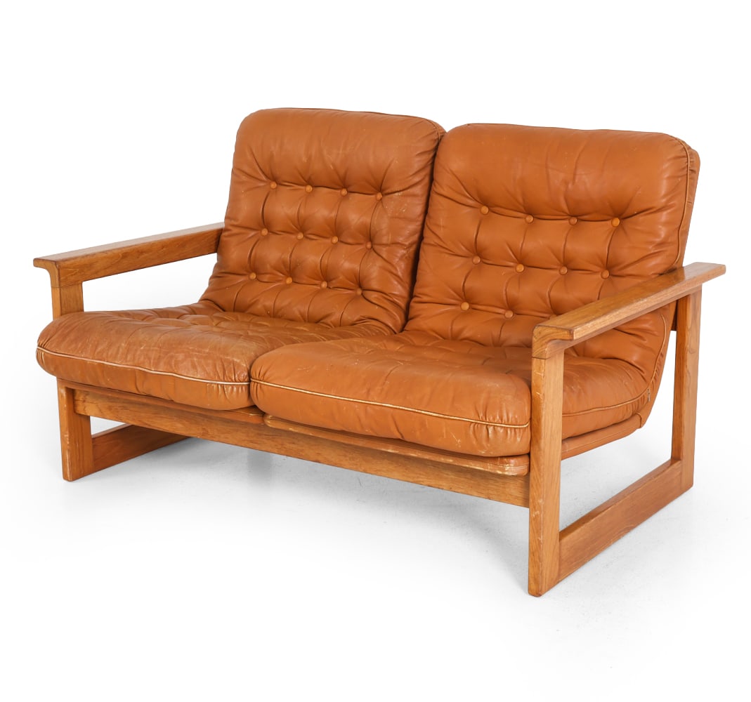 EKSTROM STYLE SWEDISH TEAK & LEATHER SOFA C. 1970S: Dimensions: H 28" x W 51" x D 29" x SH 15". Condition: Scuffs to wood and leather, fading and few small spots of discoloration to leather. Wear consistent with age and use. PT023