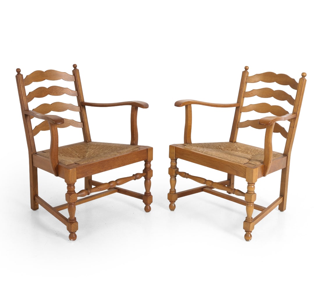 PAIR OF DUTCH OAK & RUSH ARMCHAIRS C. 1950S: Dimensions: H 33.5" x W 26" x D 20.5" x SH 16". Condition: Scuffs and rubs to wood and rush. Wear consistent with age and use. PT078