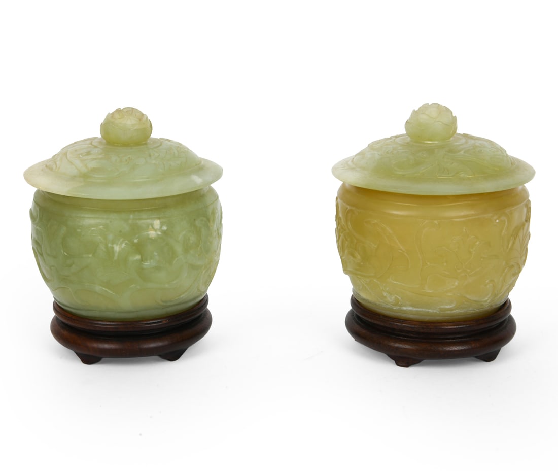 PAIR OF CHINESE CARVED JADE COVERED JARS: Apparently unmarked. Dimension: H 6" x Dia. 5.25" Condition: Light surface wear consistent with age and use.