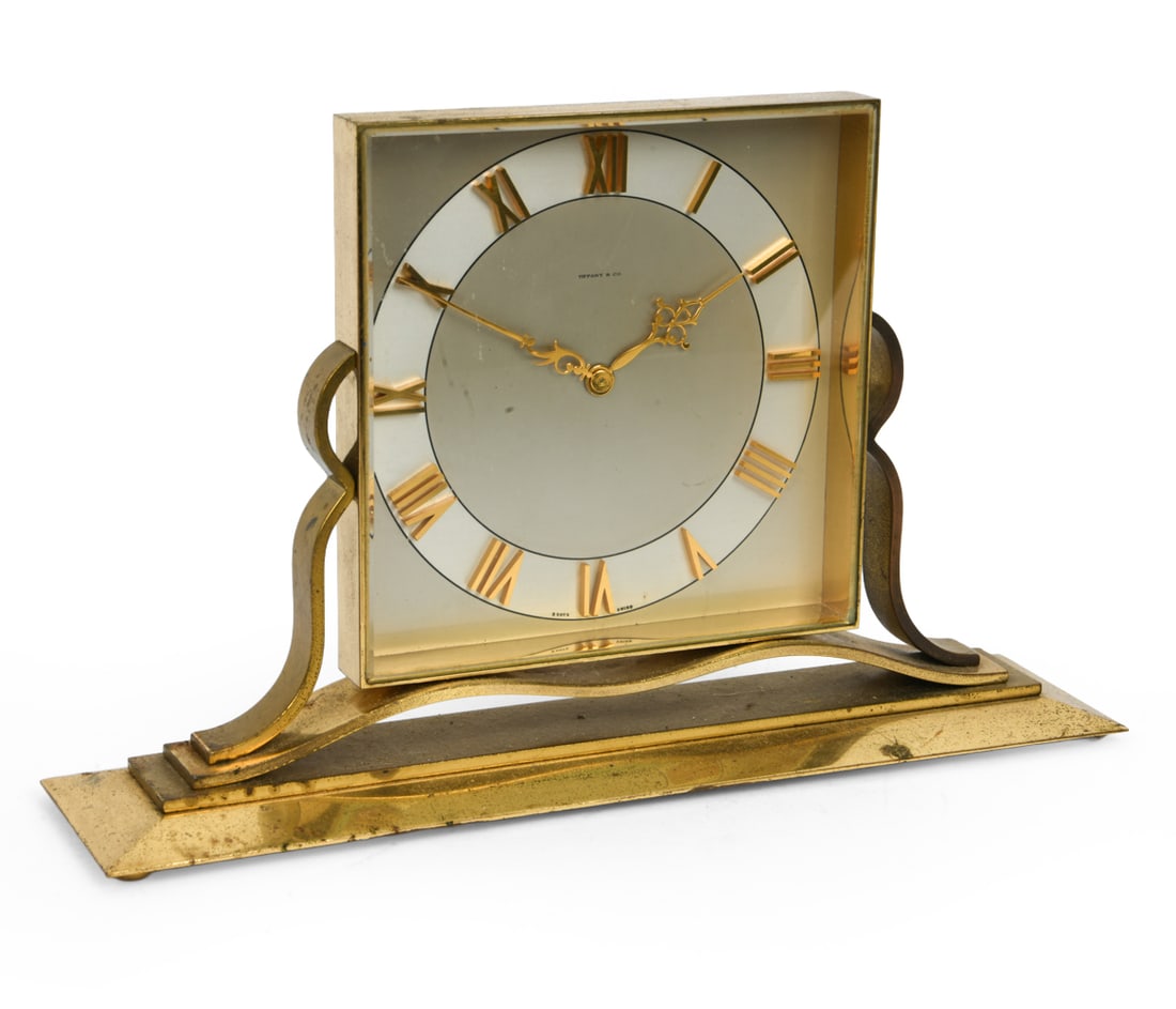 TIFFANY AND CO BRASS CLOCK: Sweden, circa 1950s-60s. Marked. Dimensions: H 7.25" x W 12" x D 3" Condition: Timekeeping untested, Scratches to clock face. Natural patina of brass.