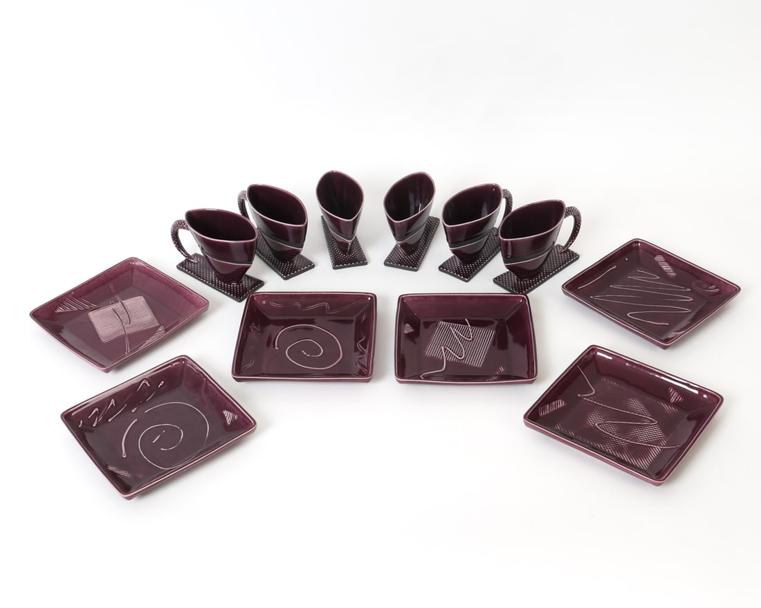 LEVY STUDIO CERAMIC SERVICE 1983: Six sculptural cups with bases and six matching square dished with geometric linear decoration in relief. Incised "levy" and dated 1983. Dimensions: (Largest) H 7" x W 8" Condition: Wear consistent