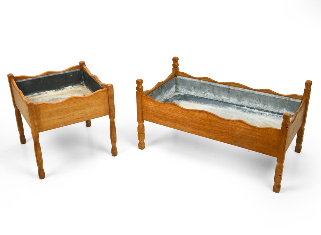 KJAERNULF STYLE DANISH OAK PLANTERS C. 1970S: (2) planters with metal trays. Denmark, circa 1970s. Dimensions: (Largest) H 17" x W 32" x D 17" Condition: Wear consistent with age and use. Soiling to tray. F074