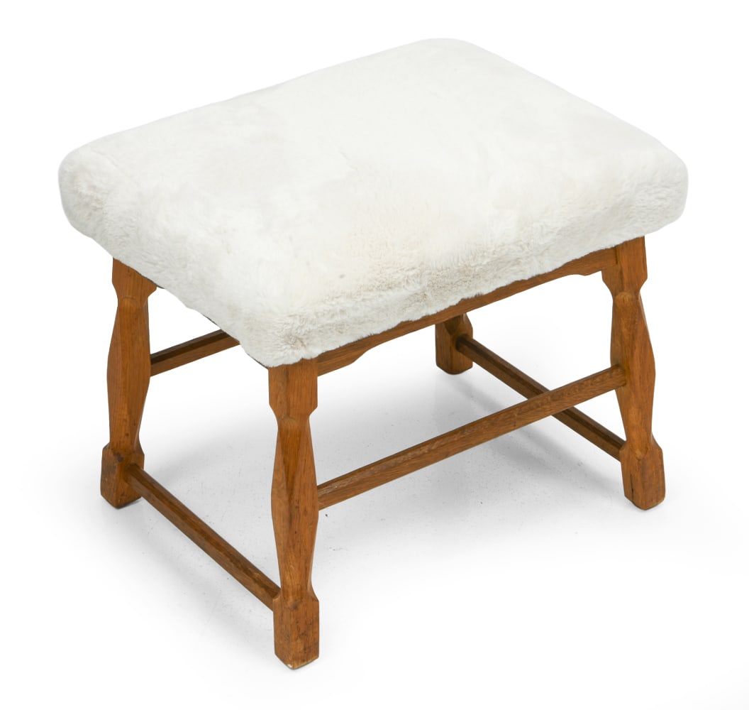 KJAERNULF STYLE DANISH OAK STOOL C. 1970S: Faux fur upholstered stool. Denmark, circa 1960s. Dimensions: H 15" x W 18" x D 14" Condition: Wear consistent with age and use. Some minor scuffs to legs.