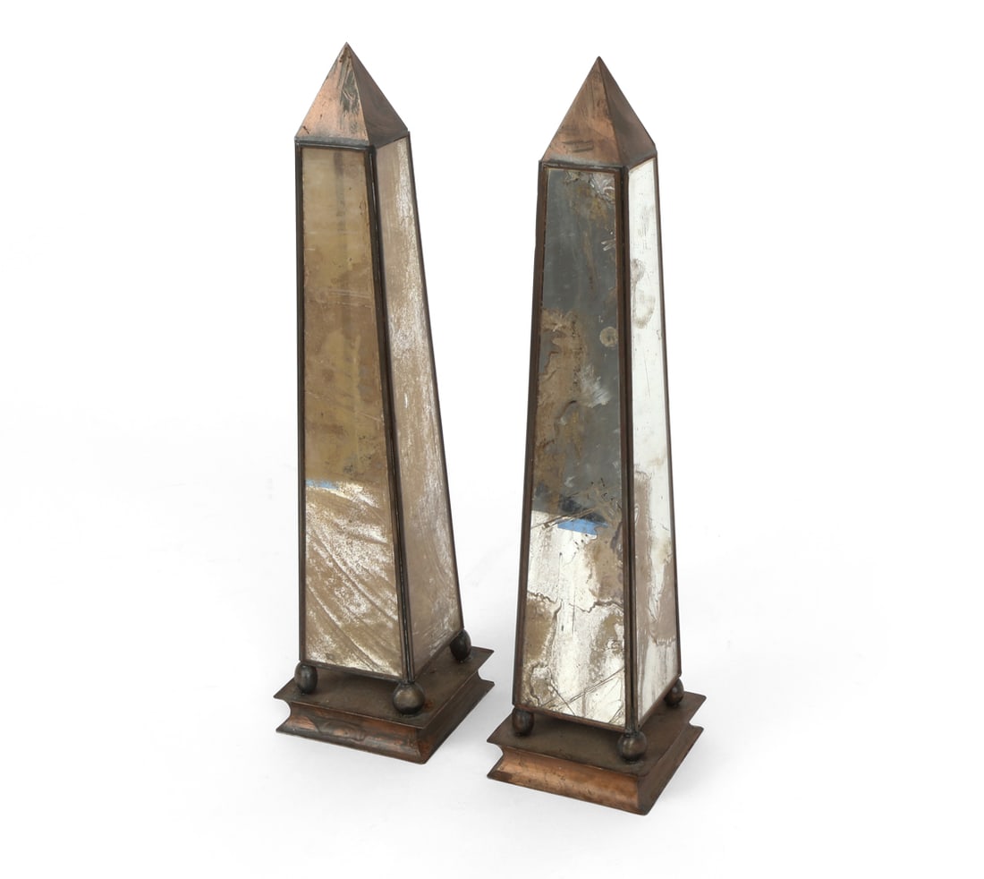 PAIR OF HOLLYWOOD REGENCY STYLE MIRRORED OBELISKS: Dimensions: H 15" x W 4" x D 4". Condition: Losses to silvering. Scuffs and rubs. Patina to metal surface. Wear consistent with age.