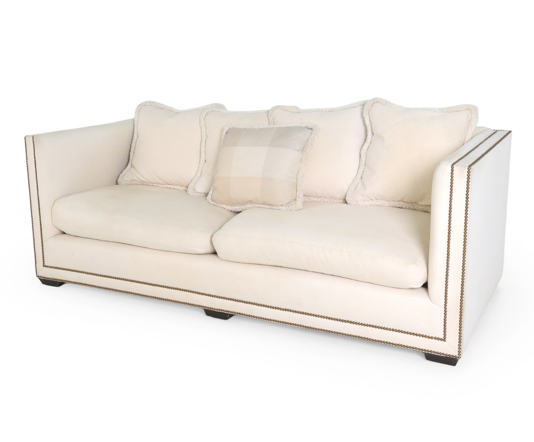 STYLE OF HAVERTY'S UPHOLSTERED TUXEDO SOFA: Tuxedo style sofa in cream tone upholstery. Brass tacks accent. With (5) cushions. Ebonized wooden feet. Apparently untagged. Dimensions: H 29.5" x W 83.5" x D 39.5" x SH 19.75". Condition: Few faint