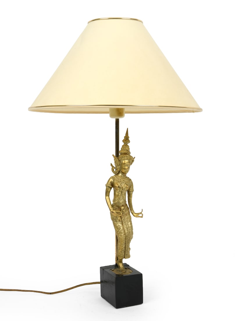 THAI DANCER FIGURAL GILT BRONZE TABLE LAMP: 20th century. Dimensions: H 25.5" x Dia. 15.5". Condition: Wiring untested. Upper ring to shade out of place. Wear consistent with age and use, including patina and scuffs. DA_105