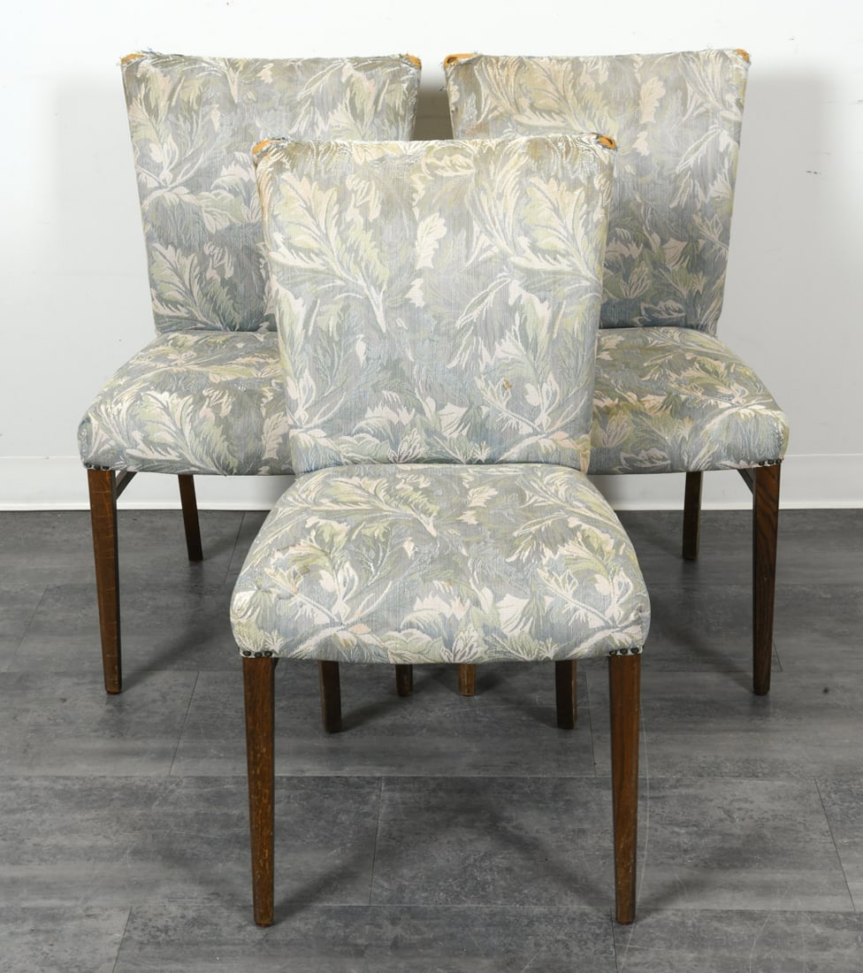 (3) DANISH SIDE CHAIRS C. 1970S: Grouping of (3) dining chairs with botanical patterned fabric upholstery. Oak legs. Denmark, circa 1970s. Dimensions: H 35" x W 19" x D 17.75" x SH 18.75". Condition: Tears to fabric. Water spots to