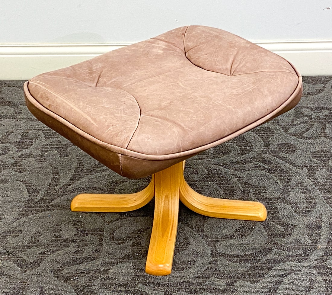 STOUBY DANISH LEATHER OTTOMAN C. 1960S: Marked on underside. Beech bentwood legs. Dimensions: H 16.25" x W 23" x D 19.75" Condition: Minor water spots to cushion, Sun-fading to cushion, Wear consistent with age and use.