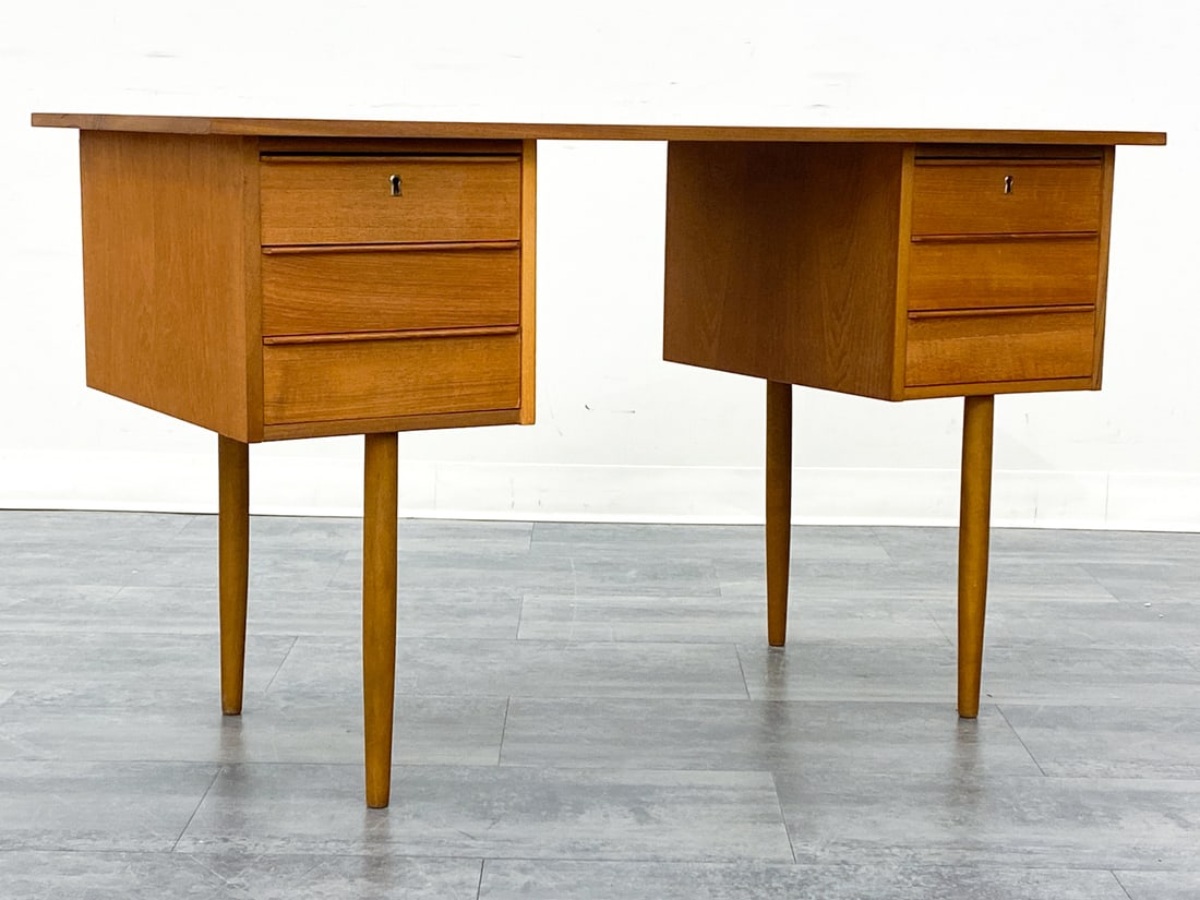 DANISH TEAK WRITING DESK CIRCA 1960S: Three drawers and a writing surface. Denmark, circa 1960S. Dimensions: H 29" x W 47.25" x D 23" Condition: Wear consistent with age and use. Discoloration, fading, marks to top. No key.