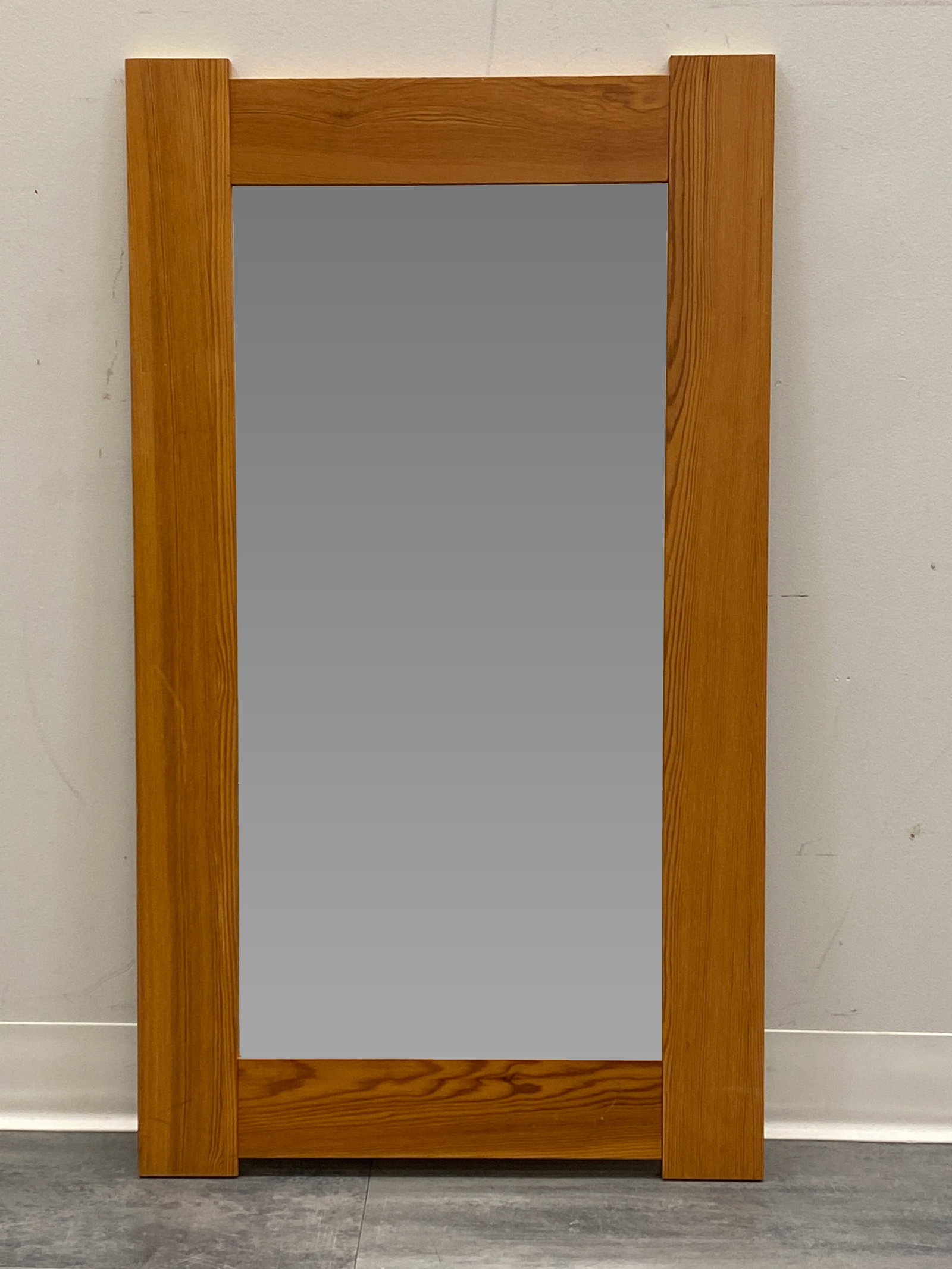 SCANDINAVIAN PINE WALL MIRROR C. 1960S: Dimensions: H 39.5" x W 22.25" Condition: Wear consistent with age and use. Minor desilvering to mirror. Some scuffs to frame.