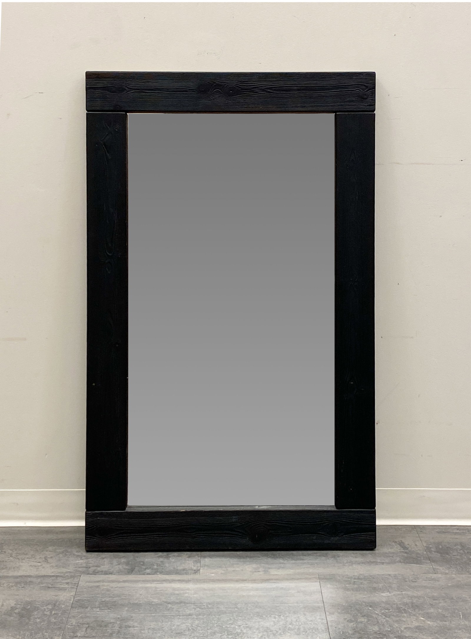 SCANDINAVIAN EBONIZED WALL MIRROR C. 1960S: Dimensions: H 51" x W 31" Condition: Wear consistent with age and use. Minor rubs to frame at the bottom.