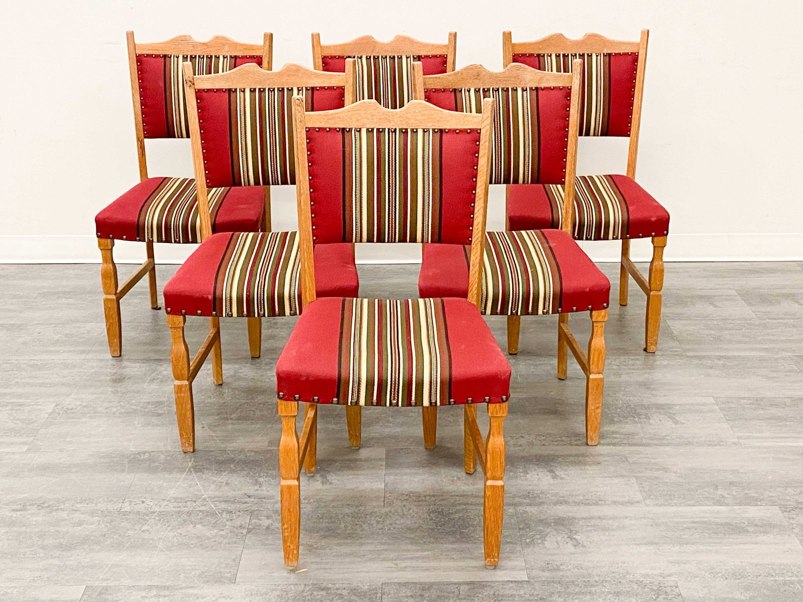 (6) KJAERNULF STYLE DANISH OAK DINING CHAIRS 1970S: Carved oak and striped upholstery. Denmark, circa 1970s. Dimensions: H 36" x W 19" x D 19" x SH 18" Condition: Wear consistent with age and use. Fading, discoloration to frame. One chair has some
