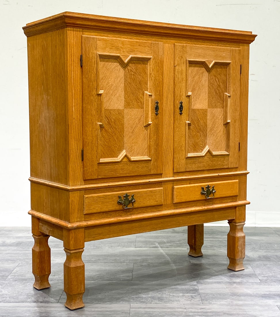 HENNING KJAERNULF DANISH OAK CABINET C. 1970S: Carved doors and brass hardware. In oak. Includes key. Apparently unmarked. Denmark, circa 1970s. Dimensions: H 47" x W 41.5" x D 16" Condition: Wear consistent with age and use. Couple of minor