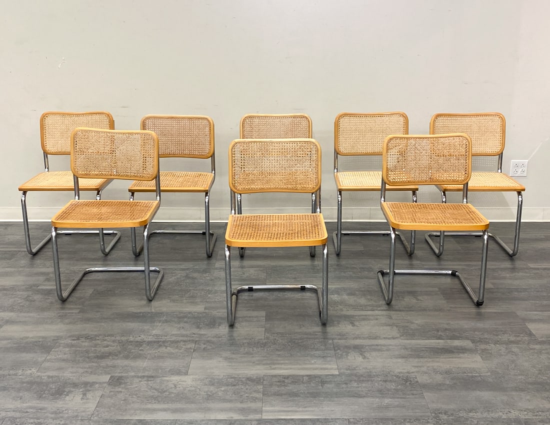 8 MARCEL BREUER STYLE ITALIAN CHROME & CANE CHAIRS: Chrome frame, beech and cane upholstery. Italy, 20th century. Dimensions: H 67" W 18.5" x D 17.75" x SH 17.75" Condition: Scuffs, wear consistent with age and use. Discoloration, fading.