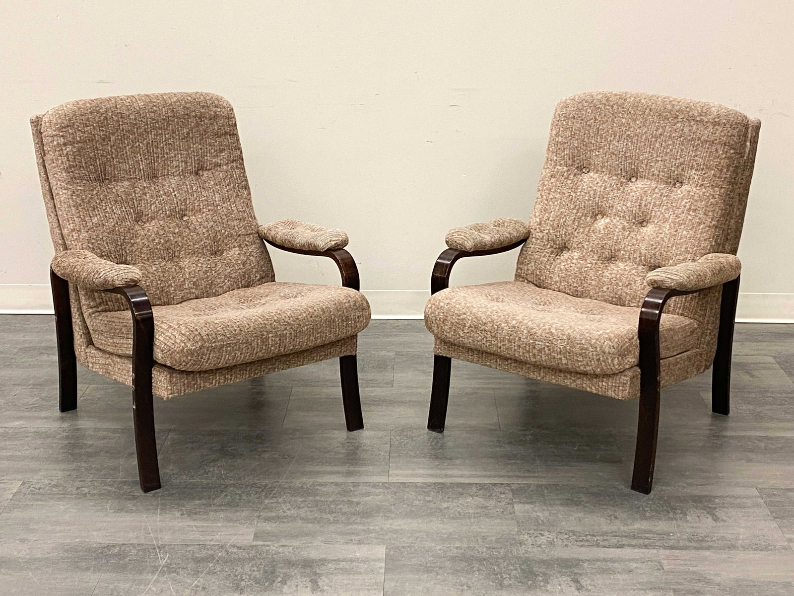 PAIR OF SCANDINAVIAN BEECH LOUNGE CHAIRS: Stained beech and tufted upholstery. Circa 1970s. Dimensions: H 34" x W 28.5" x D 31" x SH 17.5" Condition: Wear consistent with age and use. Minor nicks to legs at bottom. Some fading to armrests and