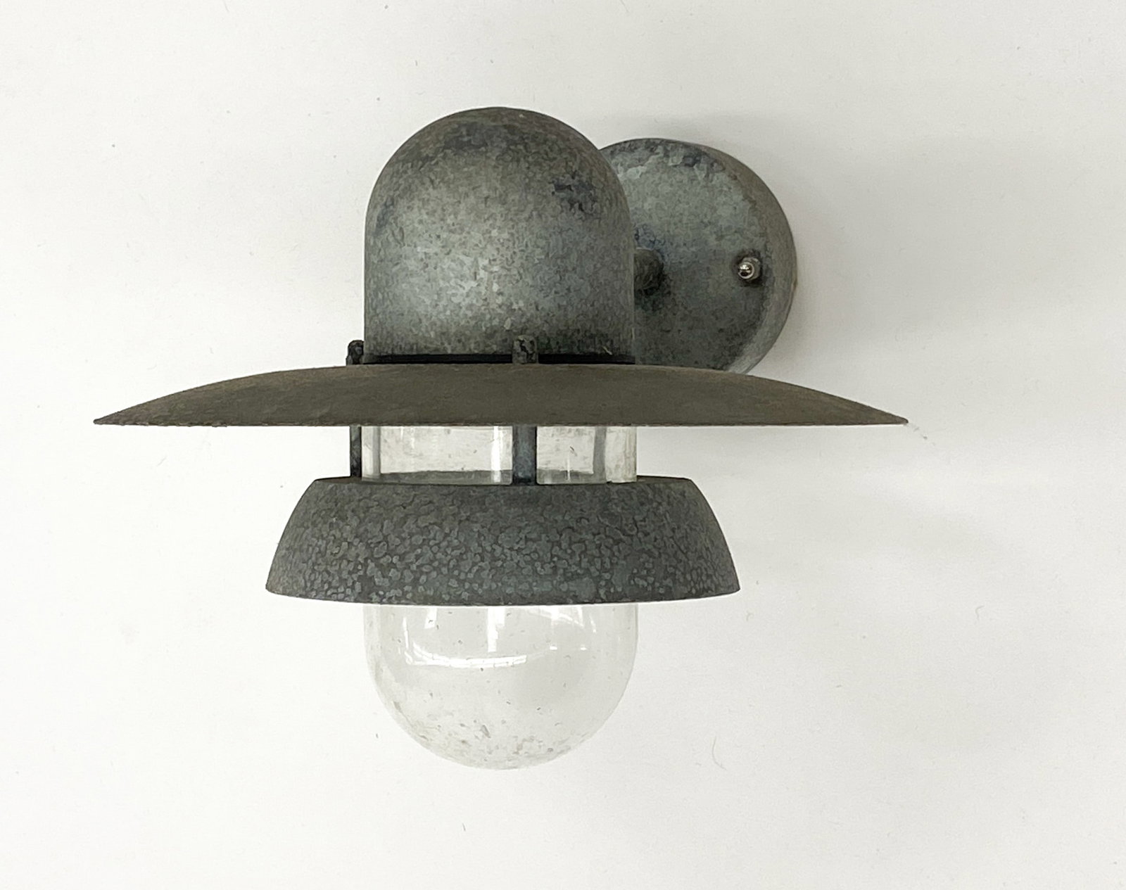 NORDLUX GALVANIZED STEEL OUTDOOR SCONCE: Outdoor sconce in tiered saucer shape. Marked to socket. Scandinavian, late 20th century. Dimensions: H 13.25" x W 11.5" x D 10" Condition: Wear consistent with age and use. Wiring untested.