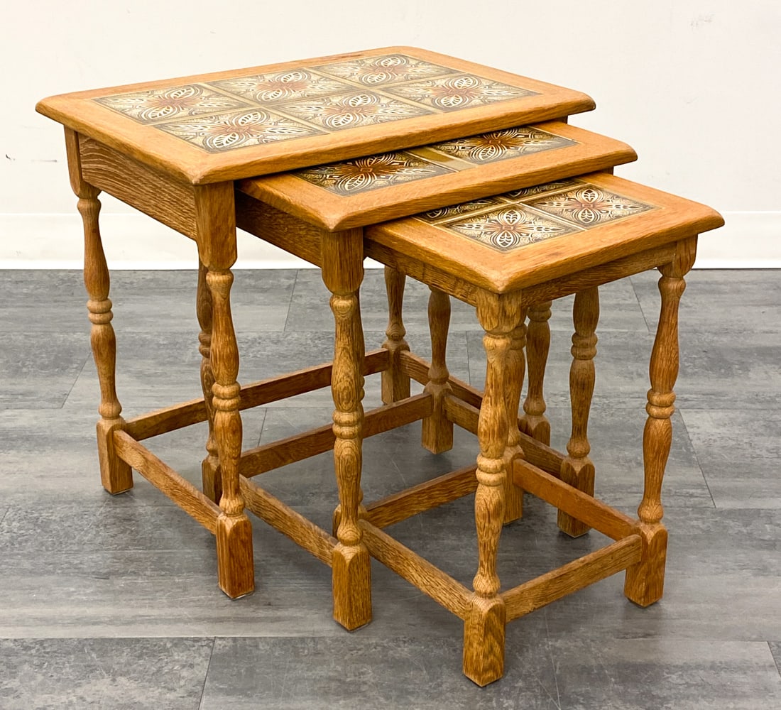 DANISH TILE & OAK NESTING TABLES C. 1970S: (3) nesting tables. Denmark, circa 1970s. Dimensions: (Largest) H 21" x W 21.5 " x D 15.5 " Condition: Scuffs, surface marks. Wear consistent with age and use. Minor soiling. Fading, some